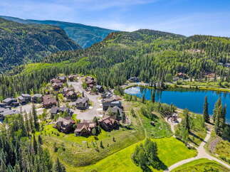 Nestled amidst a lush alpine forest, this stunning property offers breathtaking mountain views and a serene lakeside setting.