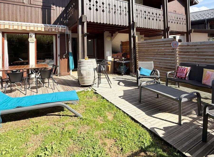 Enjoy outdoor living in this charming property featuring a spacious wooden deck perfect for al fresco dining and relaxation.