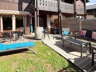 Enjoy outdoor living in this charming property featuring a spacious wooden deck perfect for al fresco dining and relaxation.