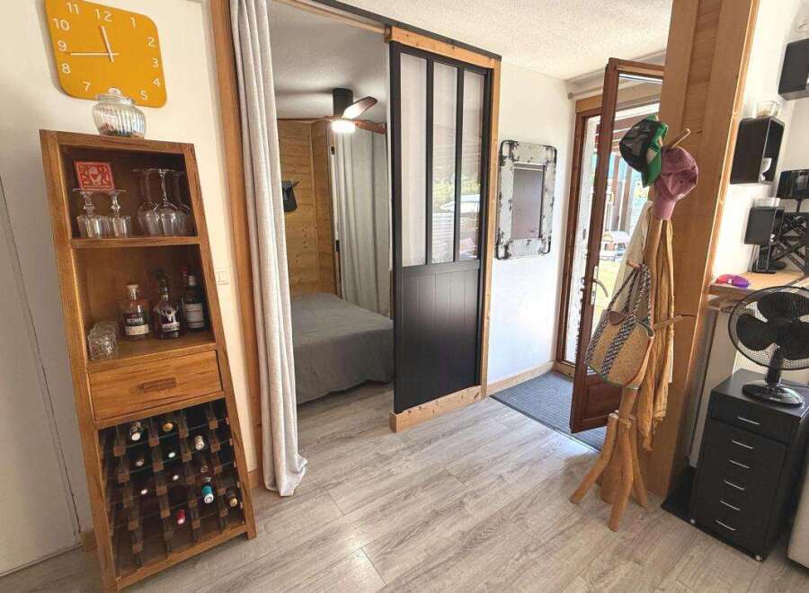 Discover this charming space featuring a rustic wooden wine rack and display cabinet, perfect for showcasing your collection.