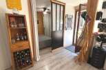 Discover this charming space featuring a rustic wooden wine rack and display cabinet, perfect for showcasing your collection.