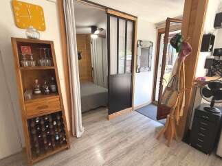 Discover this charming space featuring a rustic wooden wine rack and display cabinet, perfect for showcasing your collection.