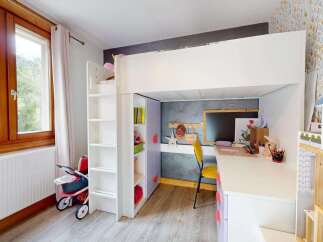 This charming children's room features a space-saving loft bed with an integrated desk and shelving, perfect for study and play.