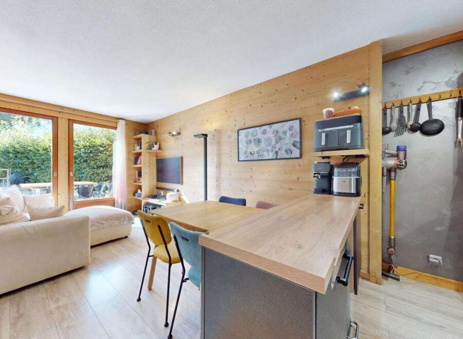 Experience modern living in this beautifully appointed apartment featuring a spacious open-plan living and dining area with a sleek kitchen island.