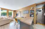 Experience modern living in this beautifully appointed apartment featuring a spacious open-plan living and dining area with a sleek kitchen island.