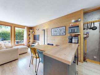 Experience modern living in this beautifully appointed apartment featuring a spacious open-plan living and dining area with a sleek kitchen island.