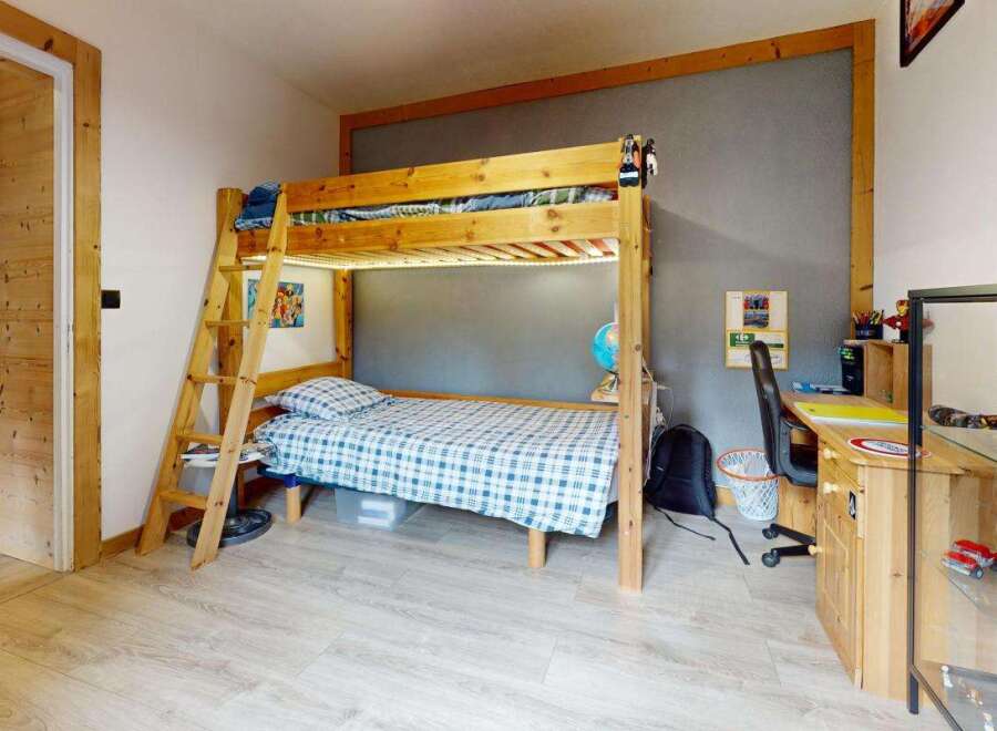 Discover this charming children's room featuring a sturdy wooden bunk bed with integrated LED lighting, perfect for sleepovers and imaginative play.
