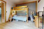 Discover this charming children's room featuring a sturdy wooden bunk bed with integrated LED lighting, perfect for sleepovers and imaginative play.