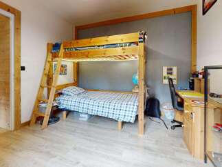 Discover this charming children's room featuring a sturdy wooden bunk bed with integrated LED lighting, perfect for sleepovers and imaginative play.