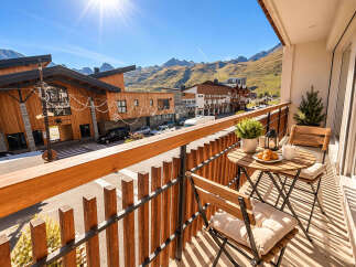 Enjoy your morning coffee or evening wine on this charming balcony, complete with a bistro set and stunning mountain views.