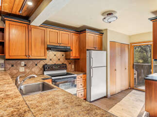 Discover this charming kitchen featuring warm wood cabinetry and a sleek granite countertop.