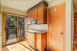 Discover this charming kitchen featuring warm wooden cabinetry and a convenient microwave.
