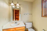 This bathroom features a classic vanity with a white sink and ample counter space, complemented by warm wooden cabinetry.