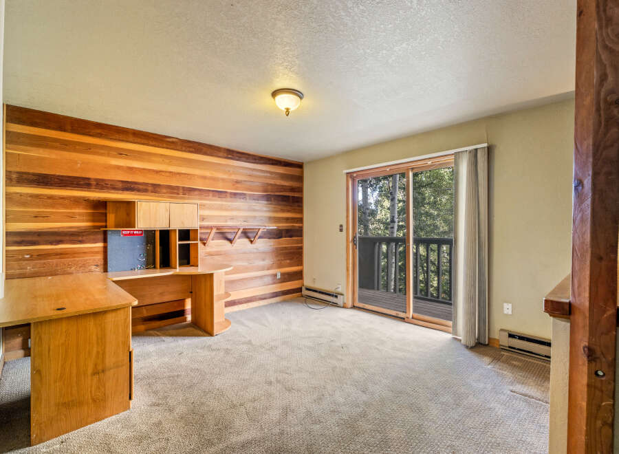 This room features a striking wood-paneled accent wall, creating a warm and inviting atmosphere.