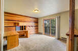 This room features a striking wood-paneled accent wall, creating a warm and inviting atmosphere.