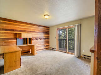 This room features a striking wood-paneled accent wall, creating a warm and inviting atmosphere.