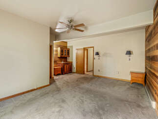 Discover this charming space featuring a built-in wet bar with rich wooden cabinetry, perfect for entertaining.