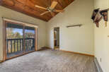 Experience breathtaking views from this spacious room featuring a vaulted wood-paneled ceiling and a convenient sliding glass door leading to a private balcony.