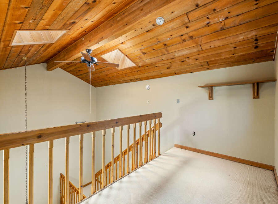 Ascend to the upper level of this charming home via a beautifully crafted wooden staircase, leading to a spacious landing.
