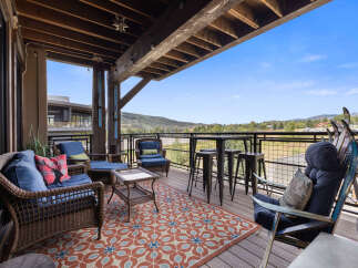 Enjoy breathtaking mountain views from this expansive covered deck, perfect for outdoor entertaining or quiet relaxation.