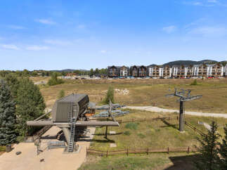 Experience mountain living with this stunning property featuring a modern ski lift station and contemporary townhomes.
