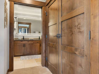 Step into a beautifully appointed bathroom featuring a double vanity with granite countertops and modern black faucets.