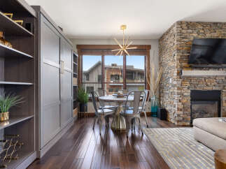Experience modern living in this stunning dining area, featuring a sleek round table with metal chairs perfect for intimate gatherings.