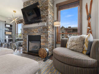 Experience cozy living with this stunning stone fireplace, perfect for gathering around on chilly evenings.