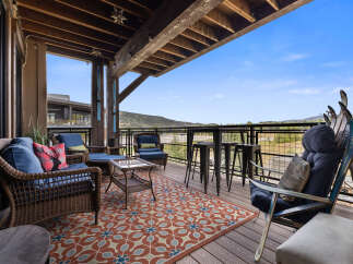Enjoy breathtaking mountain views from this expansive deck, perfect for entertaining or relaxing.