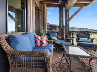 Enjoy breathtaking mountain views from this charming covered balcony, perfect for relaxing or entertaining.