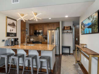 Experience modern living in this stunning kitchen featuring sleek stainless steel appliances, granite countertops, and ample cabinet space.
