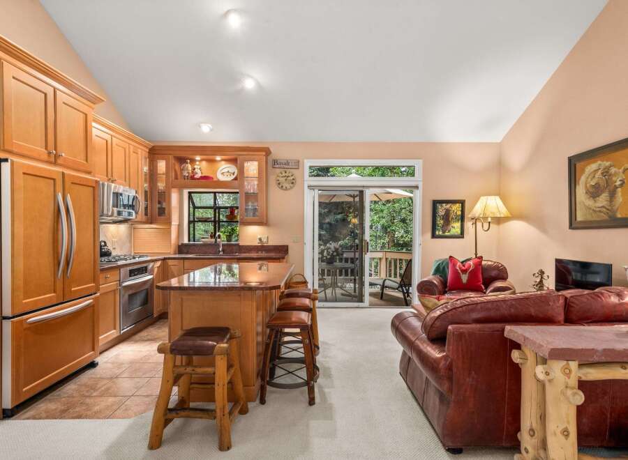 This open-concept living space seamlessly blends a gourmet kitchen with a cozy living area, perfect for entertaining.