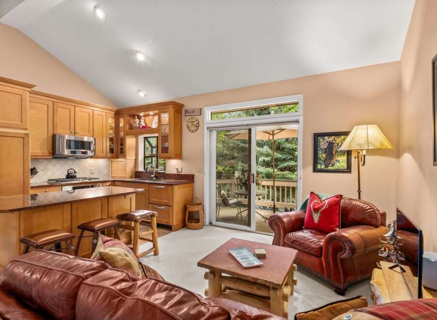 Experience comfortable living in this open-concept space featuring a well-appointed kitchen with ample cabinetry and granite countertops, seamlessly flowing into a cozy living area.