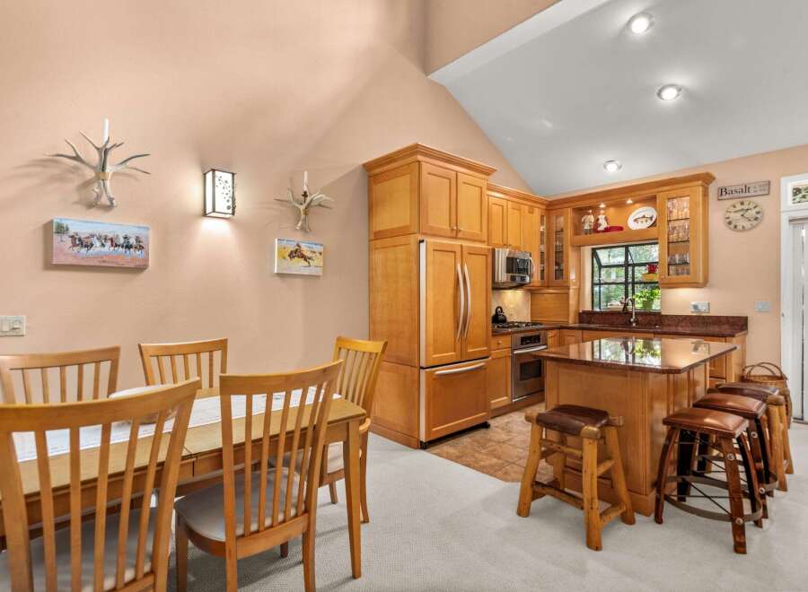 This charming kitchen and dining area features warm wood cabinetry and a spacious island perfect for casual meals or entertaining.