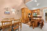 This charming kitchen and dining area features warm wood cabinetry and a spacious island perfect for casual meals or entertaining.