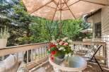 Enjoy your morning coffee on this charming balcony, complete with a glass-top table and comfortable seating.