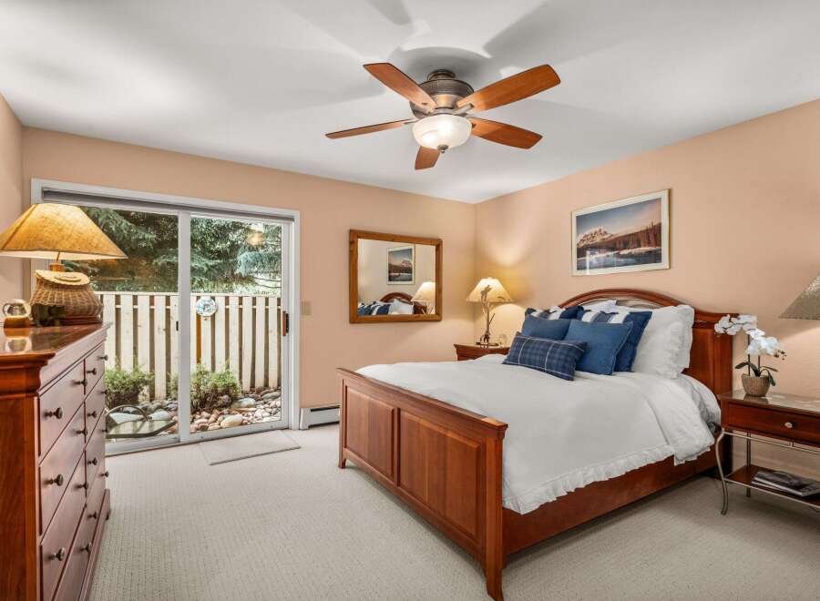 Experience comfort and style in this inviting bedroom, featuring a beautiful wooden bed frame and plush bedding.