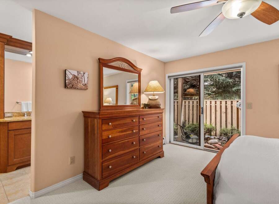 This bedroom offers a warm and inviting atmosphere with its neutral-toned walls and plush carpeting.