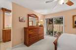 This bedroom offers a warm and inviting atmosphere with its neutral-toned walls and plush carpeting.