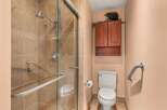 This bathroom features a spacious walk-in shower with elegant tilework and a convenient grab bar.
