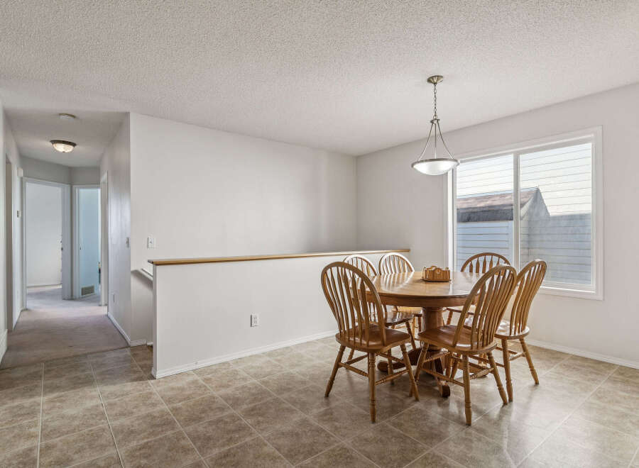 Enjoy meals in this charming dining area featuring a round wooden table with four chairs, perfect for intimate gatherings.