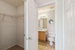 Discover a functional layout with a spacious walk-in closet featuring wire shelving, perfect for organization.
