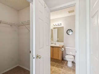 Discover a functional layout with a spacious walk-in closet featuring wire shelving, perfect for organization.