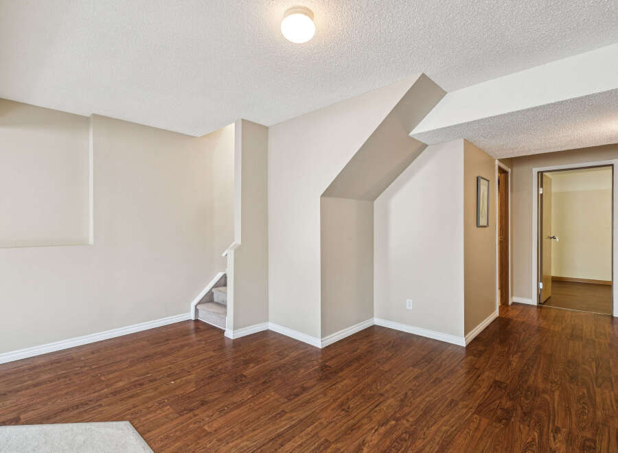 Discover this inviting space featuring rich hardwood floors and neutral-toned walls, creating a warm and versatile atmosphere.