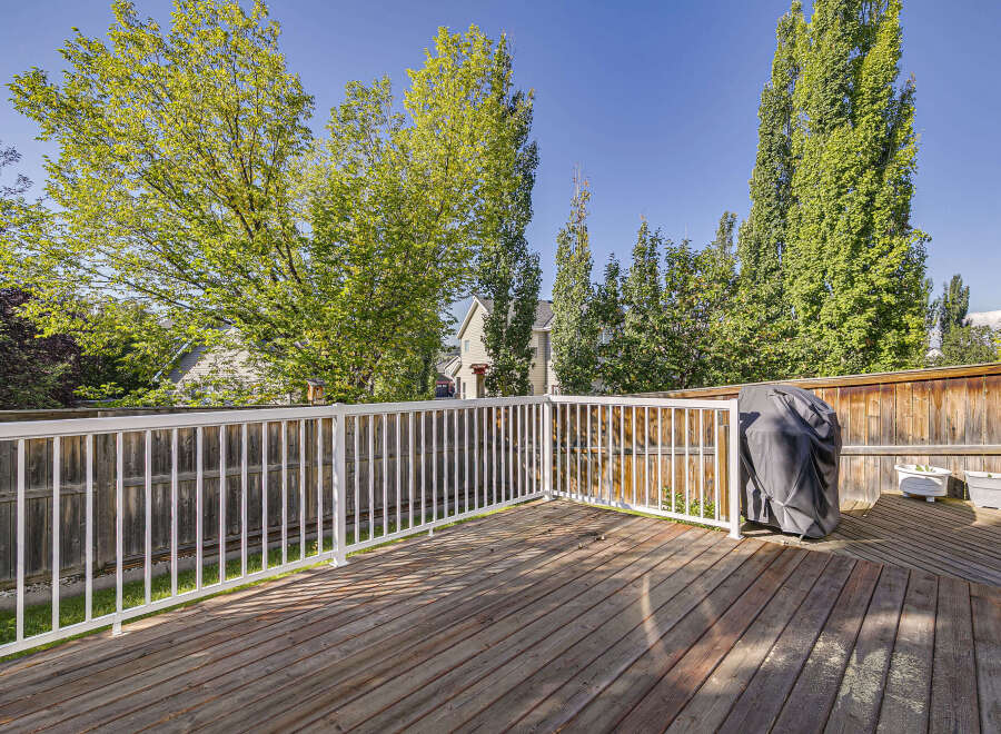 Enjoy outdoor living on this spacious wooden deck, perfect for entertaining or relaxing.