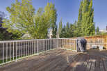 Enjoy outdoor living on this spacious wooden deck, perfect for entertaining or relaxing.