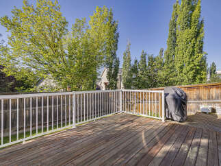 Enjoy outdoor living on this spacious wooden deck, perfect for entertaining or relaxing.
