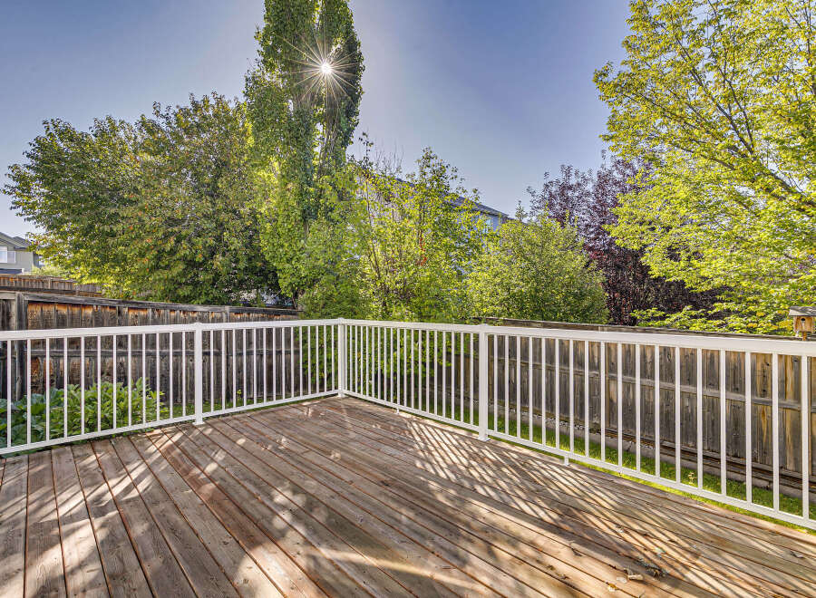 Enjoy outdoor living on this spacious wooden deck, perfect for entertaining or relaxing.