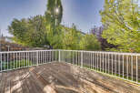 Enjoy outdoor living on this spacious wooden deck, perfect for entertaining or relaxing.