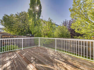 Enjoy outdoor living on this spacious wooden deck, perfect for entertaining or relaxing.